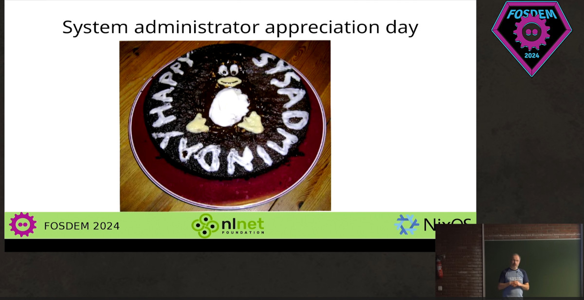 Round cake saying happy sysadmin day with a penguin in the middle.
